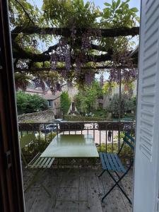 a patio with a table and chairs on a porch at Le Soleilho in Figeac