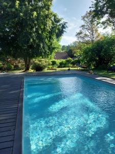 a swimming pool with blue water in a yard at Douvilla in Douville