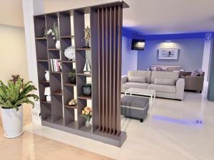 a living room with a book shelf and a couch at THE BEACH INN Cha-Am in Cha Am
