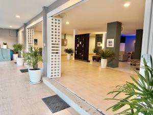 a lobby with potted plants in a building at THE BEACH INN Cha-Am in Cha Am