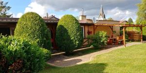a house with a group of trees in the yard at Pokoje na Okrężnej in Białogóra