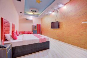 a bedroom with a bed and a tv on a wall at 6 CR Hotel Lucky Star CENTRAL BUS STOP in Aurangabad