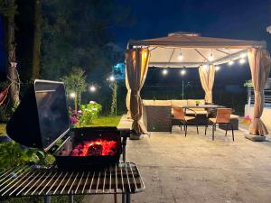 a tv sitting on a bench in a backyard at night at Дом Sand in Ureki