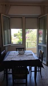 a dining room with a table with chairs and windows at Casa Sirente, Via Monte Sirente n 51 in Francavilla al Mare