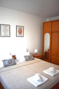 a bedroom with a bed with two towels on it at Apartmani Benedetti in Povljana