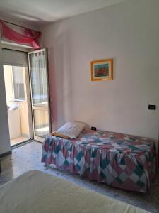 a bedroom with a bed and a large window at Casa Sirente, Via Monte Sirente n 51 in Francavilla al Mare