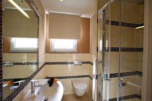 a bathroom with a sink and a toilet and a shower at Hotel C'era Una Volta in Castiglione della Pescaia