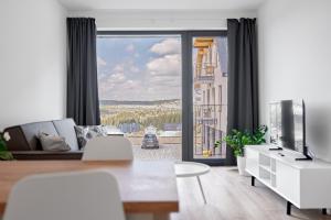 a living room with a couch and a television at Apartmány Krušec by Mountain ways in Plešivec +107 photos