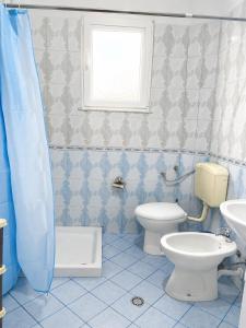 a bathroom with a toilet and a sink at Villa Ajla- Entire Villa in Durrës +12 photos