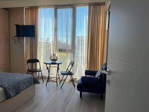 a bedroom with a bed and a table and chairs at Дом Sand in Ureki