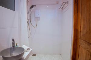 a bathroom with a shower and a sink at Neem Tree Boutique Resort in Serukele +50 photos