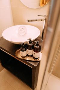 a bathroom with a sink and a counter with a sink at Quality Hosts Arlberg - AFOCH FEI - das Landhaus I SOMMERKARTE PREMIUM in Sankt Anton am Arlberg +122 photos