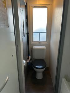 a small bathroom with a toilet and a window at camping les dolmens in Méjannes-le-Clap