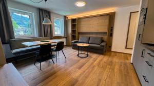 a living room with a couch and a table at Marktplatz Apartments Lofer in Lofer +17 photos