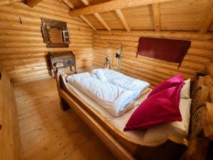 a room with a bed in a log cabin at Jørundgard Vikingcamp in Sel +31 photos