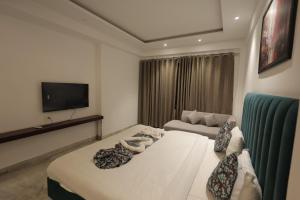 a living room with two beds and a couch at Ritz The Boutique Hotel in Rohtak