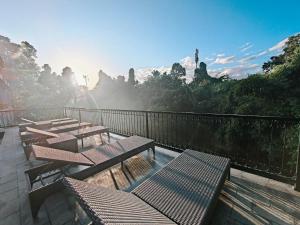 a group of picnic tables on a balcony with a view at Nawang Sakti in Ubud