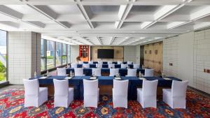 a conference room with a blue table and white chairs at Hotel Indigo Ningbo by IHG in Ningbo +186 photos