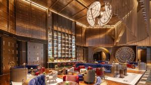 a lobby of a hotel with couches and chairs at Hotel Indigo Ningbo by IHG in Ningbo
