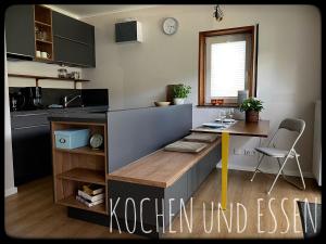 a kitchen with a counter with a table in it at Gemütliches Apartment mit Moselblick in Reil