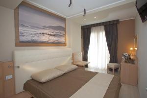 a bedroom with a large bed in a room at Hotel C'era Una Volta in Castiglione della Pescaia