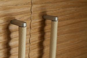 two metal stools on a wooden floor with a wire at Hotel C'era Una Volta in Castiglione della Pescaia
