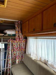an empty room with a window with a curtain at קרוואן עם חיוך in Odem