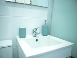 a bathroom with a sink and a mirror at Casa 4 Peixes in Leiria +13 photos
