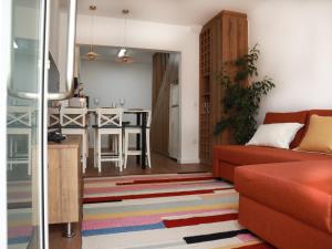 a living room with a couch and a table at Casa 4 Peixes in Leiria