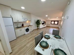 a kitchen and dining room with a table and chairs at Apartamentos TORRE DE LARA in Molina de Aragón +13 photos