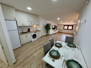 a kitchen and dining room with a table and chairs at Apartamentos TORRE DE LARA in Molina de Aragón