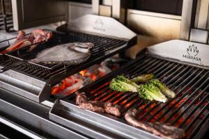 a grill with some meat and vegetables on it at Can Miquel in L'Escala