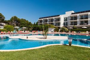 a large swimming pool in front of a building at Can Miquel in L'Escala