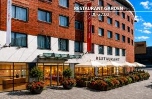 a hotel with tables and umbrellas in front of a building at Iris Hotel Eden - Czech Leading Hotels in Prague