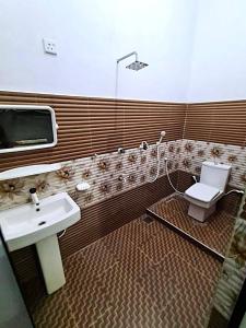 a bathroom with a sink and a toilet at Kanthans Lighthouse Cabanas in Komari +25 photos