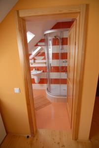 a bathroom with a shower and a sink at Penzion Dvůr in Obora