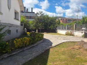 a stone walkway in front of a building at Casa con bosque en Cantabria in Ramales de la Victoria
