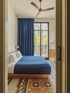 a bedroom with a bed and a large window at Hotel Casa Bonay & Spa in Barcelona +108 photos