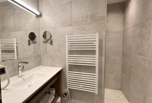 a bathroom with a sink and a shower at Marktplatz Apartments Lofer in Lofer