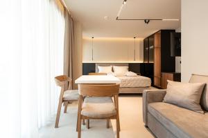 a room with a bed and a table and a couch at AVAIA boutique hotel in Nea Moudania
