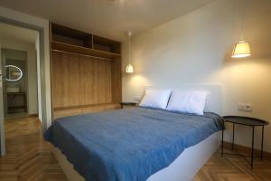 a bedroom with a bed with blue sheets and two pillows at Family House in Lakones in Paleokastritsa