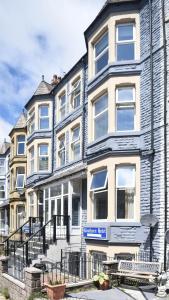a building with a blue sign on the front of it at The Bay by Guestz in Morecambe