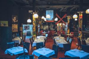 a dining room with blue tables and chairs at Hotel Utopía by MA 22 Puntos in Benalup Casas Viejas