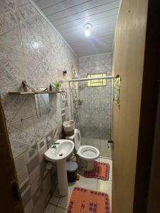 a bathroom with a toilet and a sink at Casa de Gente Feliz in Cuiabá
