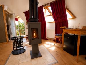 a living room with a wood burning stove in it at Soho-place in Bran