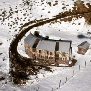 an aerial view of a building in the snow at Refugio de Montaña Placaroja in San José de Maipo +15 photos