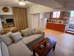 a living room with a couch and a table at Czarina Cabin הבקתה הקיסרית והדירה הקיסרית czarina apartment in Caesarea