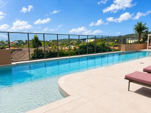 a swimming pool on the roof of a building at Lumi Residence Robina in Gold Coast