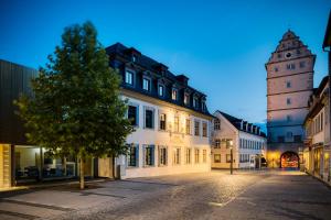 a city street with a building and a clock tower at Hotel Schwan & Post in Bad Neustadt an der Saale