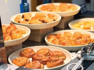 a group of bowls of pastries on a table at Hotel Faranda Los Tilos, Ascend Hotel Collection in Santiago de Compostela
